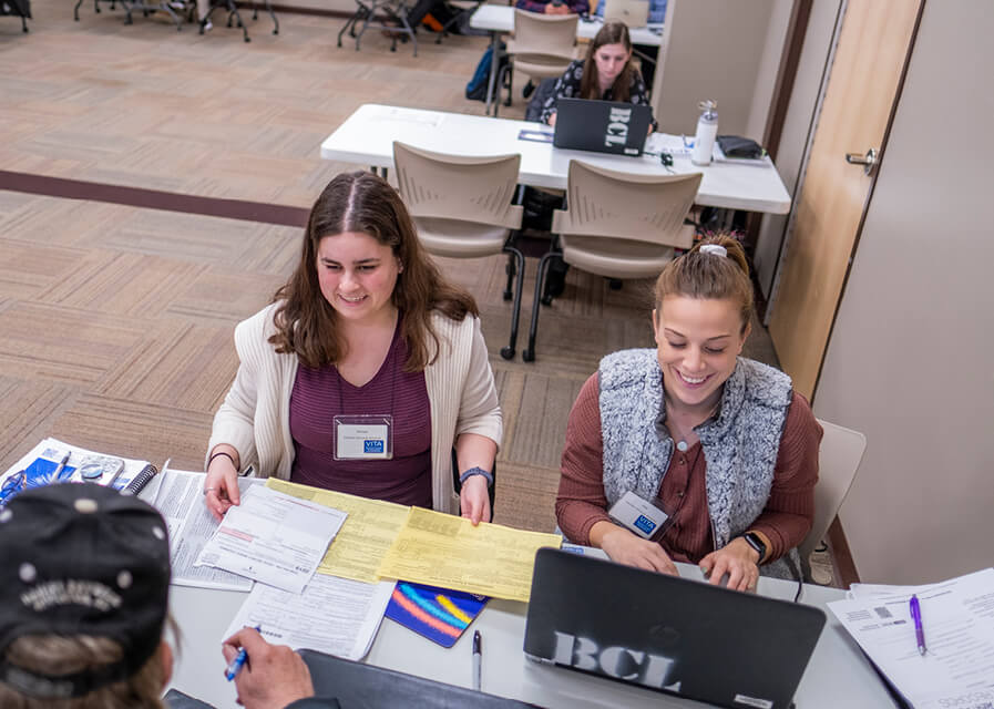 Students from the accounting program work on taxes.