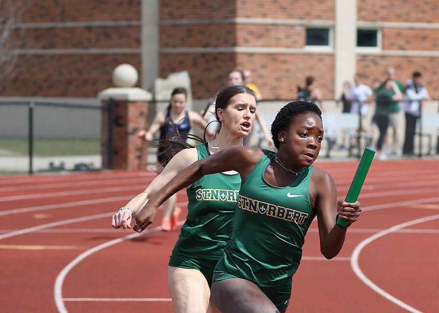 An athlete competing in a baton race