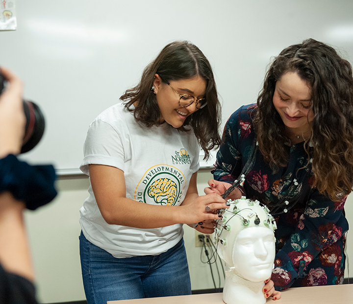 Raquel Lopez and student work on a research project